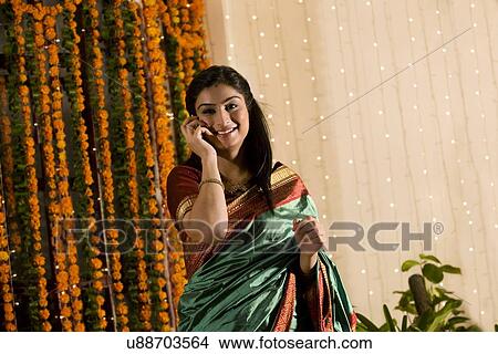 Woman talking on a mobile phone View Large Photo Image Picture - Woman talking on a mobile phone . Fotosearch
