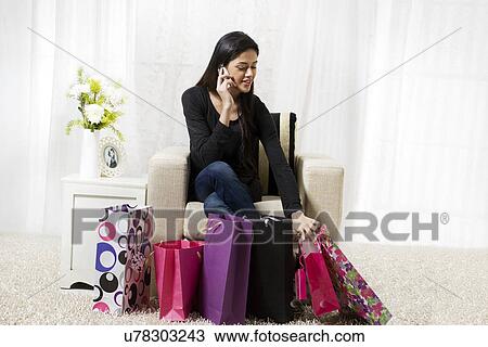 Stock Image - Woman talking on a mobile phone . Fotosearch