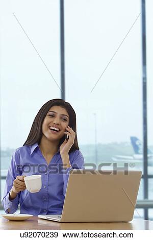 Woman talking on a mobile phone View Large Photo Image Stock Photo - Woman talking on a mobile phone . Fotosearch