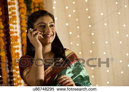 Stock Photography - Woman talking on a mobile phone . Fotosearch