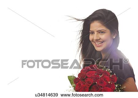 Woman with a bouquet of roses smiling View Large Photo Image Stock Photo - Woman with a bouquet of roses smiling. Fotosearch