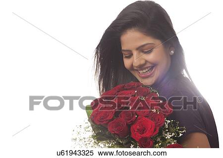 Woman with a bouquet of roses smiling View Large Photo Image Stock Photography - Woman with a bouquet of roses smiling. Fotosearch