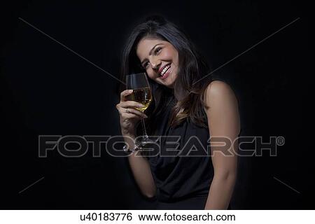 Woman with a glass of wine enjoying herself View Large Photo Image Stock Photograph - Woman with a glass of wine enjoying herself. Fotosearch