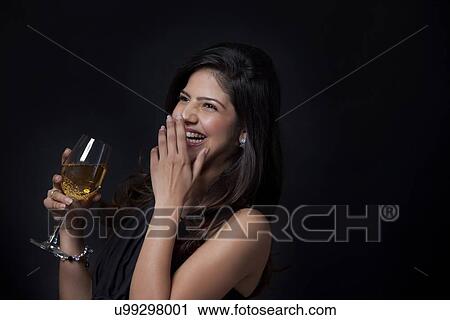 Woman with a glass of wine laughing View Large Photo Image Stock Image - Woman with a glass of wine laughing. Fotosearch