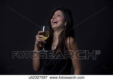 Stock Photo - Woman with a glass of wine laughing. Fotosearch