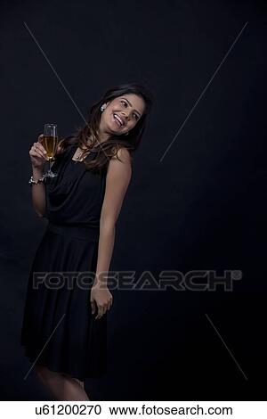 Stock Image - Woman with a glass of wine smiling. Fotosearch