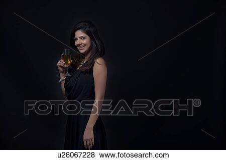 Stock Photo - Woman with a glass of wine smiling. Fotosearch