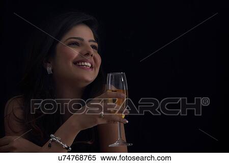 Stock Photography - Woman with a glass of wine smiling. Fotosearch