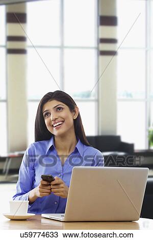 Woman with a mobile phone thinking View Large Photo Image Stock Image - Woman with a mobile phone thinking . Fotosearch