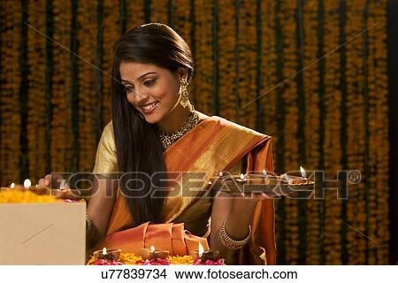 Woman with a tray of diyas View Large Photo Image Picture - Woman with a tray of diyas . Fotosearch