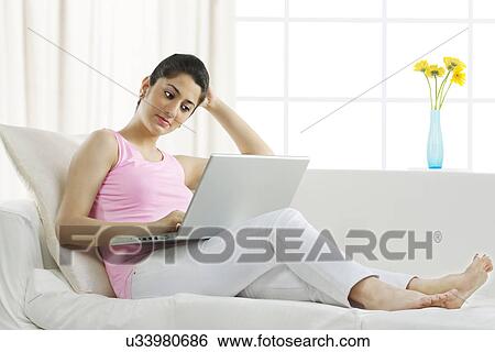 Stock Photograph - Woman working on a laptop . Fotosearch