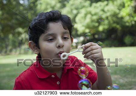 Young boy blowing bubbles View Large Photo Image Stock Image - Young boy blowing bubbles. Fotosearch