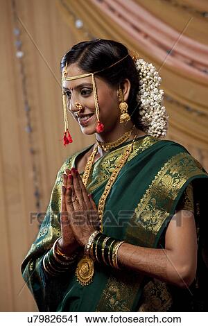 Stock Image - Young bridal praying with hands clasped . Fotosearch