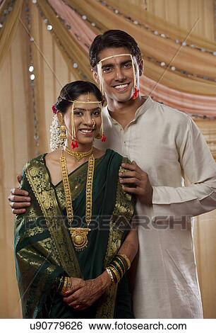 Stock Photograph - Young bride and groom smiling together on wedding day . Fotosearch
