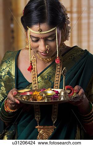 Young bride taking a bow with offerings View Large Photo Image Picture - Young bride taking a bow with offerings . Fotosearch