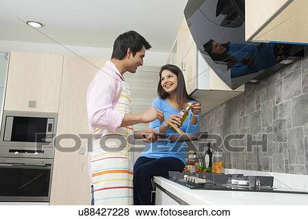 Young couple cooking food in kitchen View Large Photo Image Stock Photo - Young couple cooking food in kitchen. Fotosearch