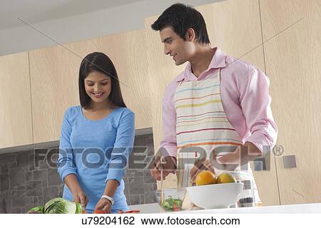 Young couple preparing salad in kitchen View Large Photo Image Stock Image - Young couple preparing salad in kitchen. Fotosearch