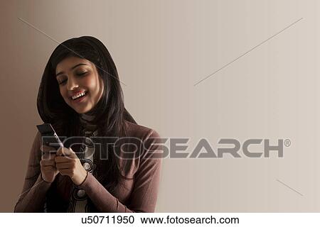 Young girl sending an sms View Large Photo Image Stock Image - Young girl sending an sms . Fotosearch