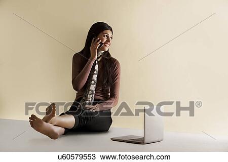 Young girl talking on a phone View Large Photo Image Stock Image - Young girl talking on a phone . Fotosearch