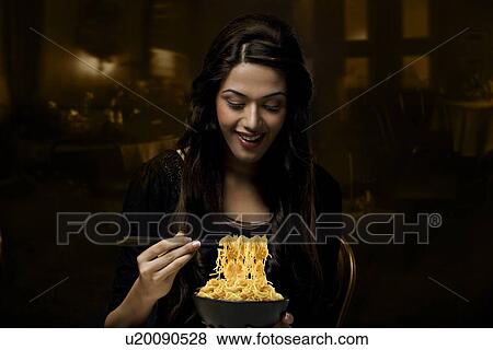 Young girl with a bowl of noodles View Large Photo Image Stock Photo - Young girl with a bowl of noodles . Fotosearch
