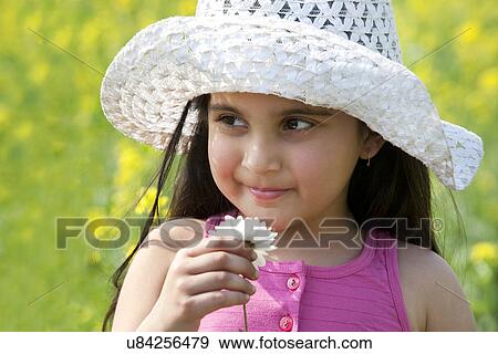 Young girl with a flower View Large Photo Image Stock Photo - Young girl with a flower . Fotosearch