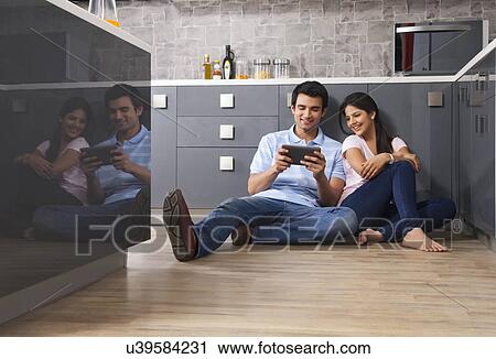 Young Indian couple using digital tablet in kitchen View Large Photo Image Stock Image - Young Indian couple using digital tablet in kitchen. Fotosearch