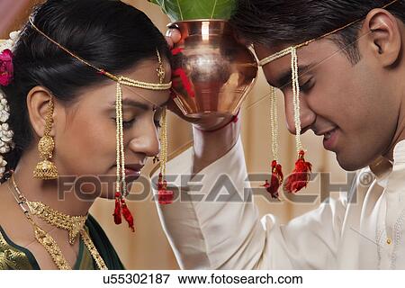 Young Maharashtrian bride and groom performing rituals together View Large Photo Image Stock Photo - Young Maharashtrian bride and groom performing rituals together . Fotosearch