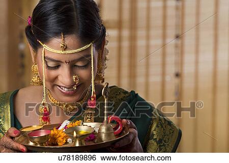Young Maharashtrian bride giving offerings View Large Photo Image Stock Photograph - Young Maharashtrian bride giving offerings . Fotosearch