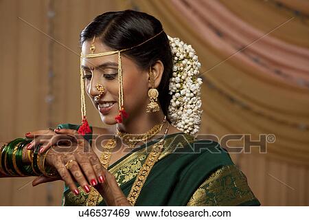 Young Maharashtrian bride wearing bangles View Large Photo Image Stock Photo - Young Maharashtrian bride wearing bangles . Fotosearch