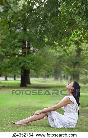 Young woman enjoying nature View Large Photo Image Picture - Young woman enjoying nature . Fotosearch