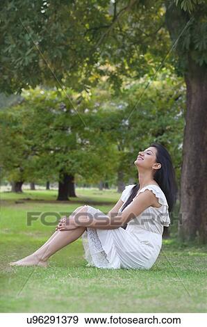 Stock Photo - Young woman enjoying nature . Fotosearch