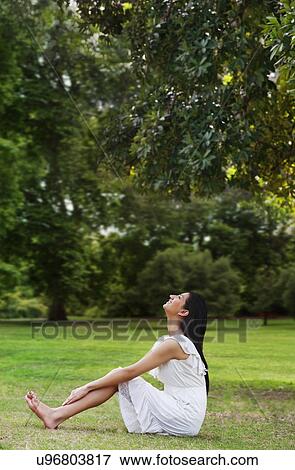 Stock Photo - Young woman enjoying nature . Fotosearch