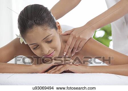 Young woman getting a back massage at spa View Large Photo Image Picture - Young woman getting a back massage at spa . Fotosearch