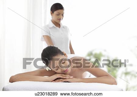 Stock Photo - Young woman having a massage . Fotosearch