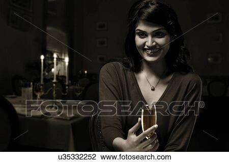 Young woman holding a wine glass View Large Photo Image Stock Image - Young woman holding a wine glass . Fotosearch