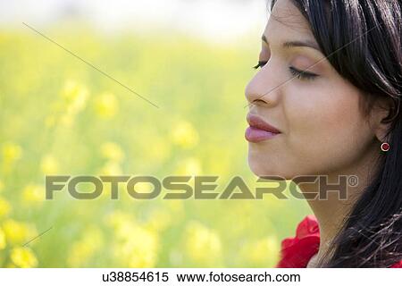 Young woman in a field View Large Photo Image Stock Photography - Young woman in a field . Fotosearch