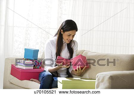 Young woman looking inside a gift box View Large Photo Image Stock Image - Young woman looking inside a gift box . Fotosearch