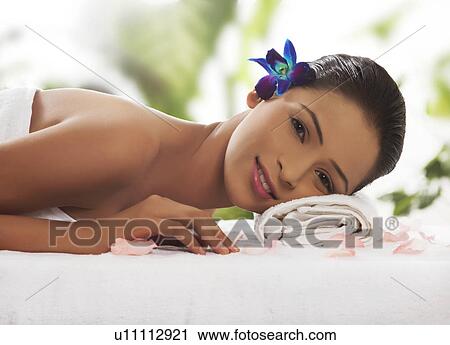 Stock Image - Young woman lying on massage table . Fotosearch