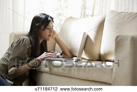 Young woman surfing the internet View Large Photo Image Stock Image - Young woman surfing the internet . Fotosearch