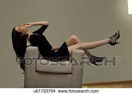 Young woman talking on a mobile phone View Large Photo Image Picture - Young woman talking on a mobile phone . Fotosearch