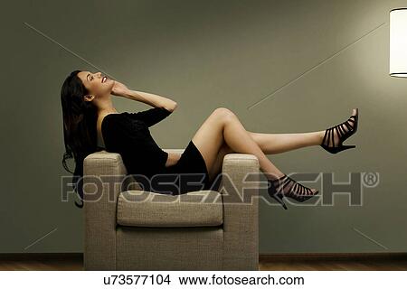 Young woman talking on a mobile phone View Large Photo Image Picture - Young woman talking on a mobile phone . Fotosearch