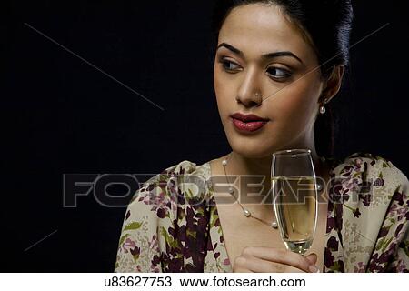 Young woman with a glass of wine View Large Photo Image Stock Image - Young woman with a glass of wine . Fotosearch