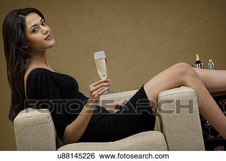 Stock Photograph - Young woman with a glass of wine . Fotosearch