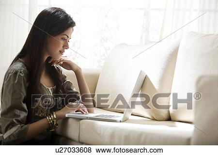 Young woman with a laptop View Large Photo Image Stock Photo - Young woman with a laptop . Fotosearch