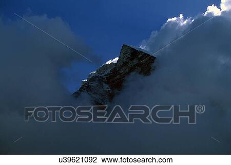 A clouded peak of a mountain View Large Photo Image Stock Image - A clouded peak of a mountain. Fotosearch