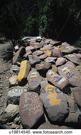 Buddhist mantras on stones View Large Photo Image Stock Image - Buddhist mantras on stones. Fotosearch