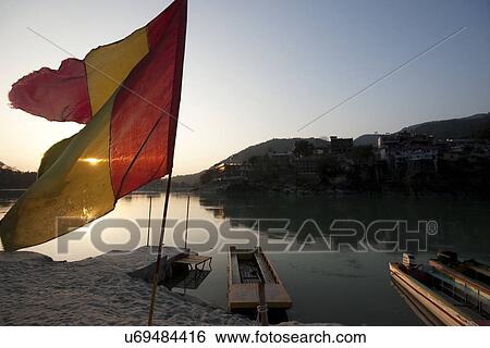 Religious flag fluttering in the sunset View Large Photo Image Stock Photograph - Religious flag fluttering in the sunset . Fotosearch
