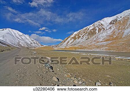 Stock Photograph - Roads bisecting mountains. Fotosearch