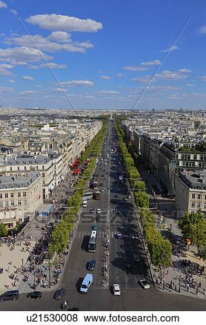 Stock Photo - Aerial view of Paris, France as seen from the Arch of Triumph on a sunny day with white puffy clouds. Fotosearch