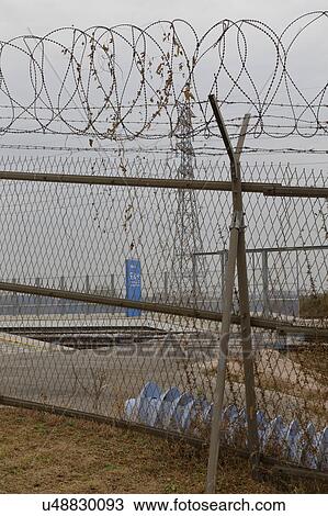 Barbed wire fence separates South from North Korea - Asia View Large Photo Image Stock Image - Barbed wire fence separates South from North Korea - Asia. Fotosearch